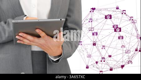 Using tablet, business professional interacting with digital network interface in office Stock Photo