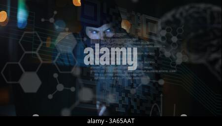Image of data processing and glowing brain over hacker using computer Stock Photo