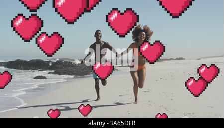 Image of heart digital icons over couple running and holding hands on beach Stock Photo