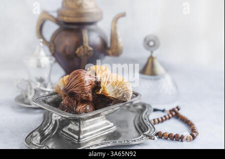 Baklava. Traditional Middle Eastern sweets served with an ornate teapot in an elegant setting. Stock Photo