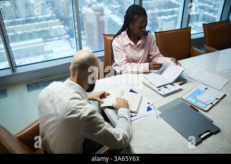 Colleagues Discussing Plans At Meeting Stock Photo