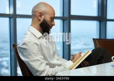 Businessman Making Notes In Notebook Stock Photo