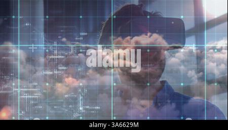 Man using VR headset exploring digital cloud technology in modern office Stock Photo