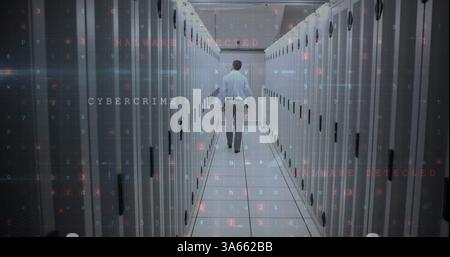 Walking through data center, technician addressing cybercrime and malware threats Stock Photo