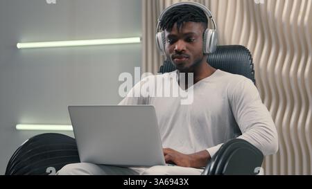 Futurism African American man male programmer developer designer cyber data guy in white futuristic room indoors cyberspace modern technology put on Stock Photo