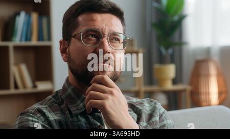 Portrait pensive thinking hesitate unsure think thoughtful confused puzzled Caucasian man male guy come up with idea finding answer creative solution Stock Photo