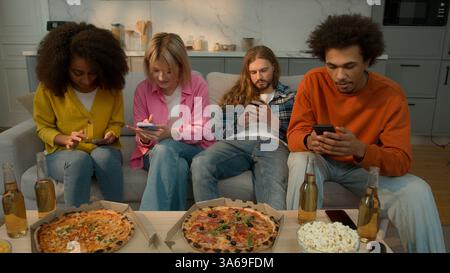 Multiracial friends multiethnic diversity people gadgets addict together using mobile phones smartphones addiction overuse ignoring boring addicted Stock Photo