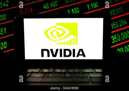 In this photo illustration a Nvidia technology company logo seen displayed on a smartphone with stock numbers on the background. Stock Photo