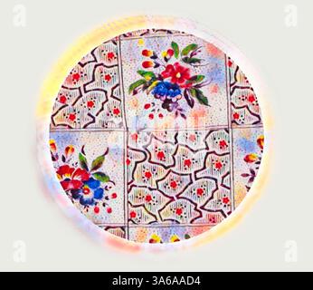 A circular decorative plate featuring intricate floral patterns in vibrant colors, displaying a blend of red, blue, and green hues against a delicately patterned background. Classic art with a modern twist reimagined by Artotop, Transformed French Fabrics, First Half of the Nineteenth Century Stock Photo
