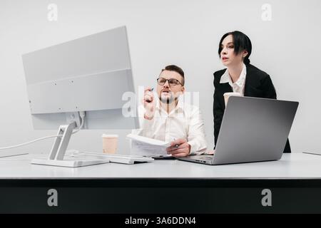 Specialists in the office discuss and solve the problem of declining sales and revenues. The concept is to show teamwork, analysis Stock Photo