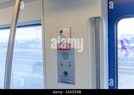 Emergency Brake in a Dutch train with emergency intercom button. Stock Photo