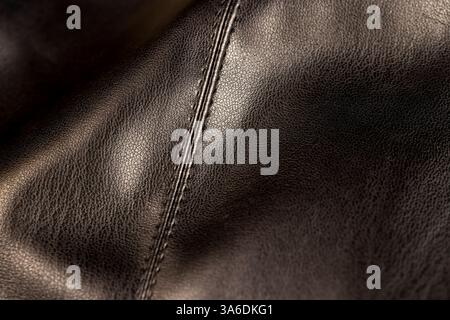 synthetic black leather fabric for the manufacture , a part of synthetic fabric used for sewing trousers and other types of fashionable clothing Stock Photo