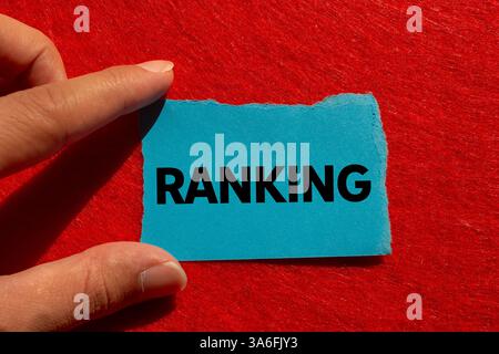 Ranking message written on ripped torn blue paper on red background. Conceptual ranking symbol. Copy space. Stock Photo