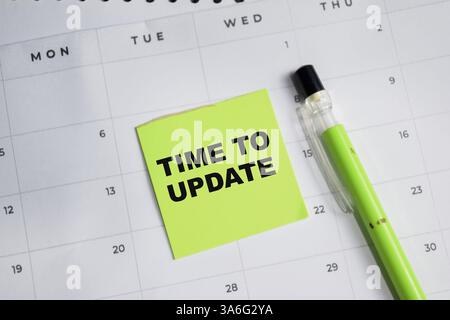 Concept of Time to Update write on sticky notes and calendar isolated on Wooden Table. Stock Photo