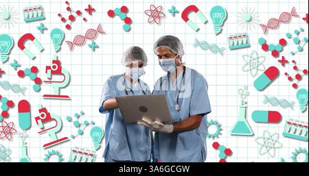 Medical professionals in scrubs using laptop, collaborating on scientific research. Healthcare, teamwork, collaboration, technology, innovation, hospi Stock Photo