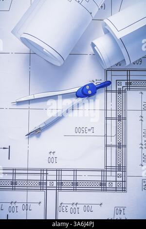 Compass One Blueprint Map compass and two rolled up white blueprints Stock Photo - Alamy