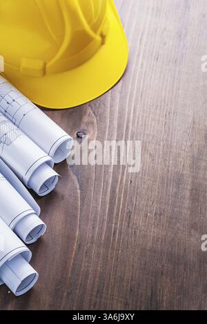 rolls of blueprints and yellow helmet Stock Photo - Alamy