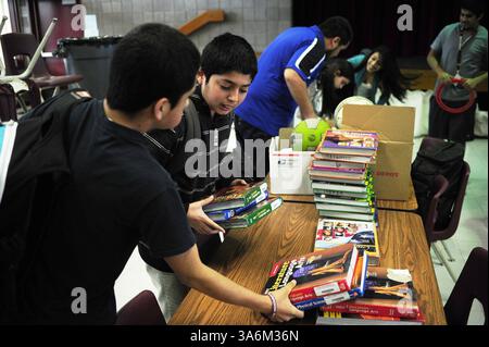 Feb. 3, 2015 - California, U.S. - Junior high students Marcos Castillo, 13, left, and Jason Silva, 13, gather books to use for homework before doing other activities, at the After School Education and Safety Program, or ASES, at Hanshaw Middle School in Modesto on Tuesday  (Credit Image: © Christopher Winterfeldt/Modesto Bee/ZUMA Wire) Stock Photo