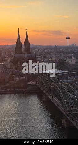 A breathtaking view of the Cologne skyline during sunset featuring the ...
