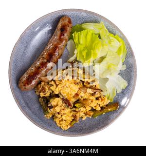 Scrambled eggs with mushrooms, chicken fillet and asparagus with sausages are served on plate Stock Photo