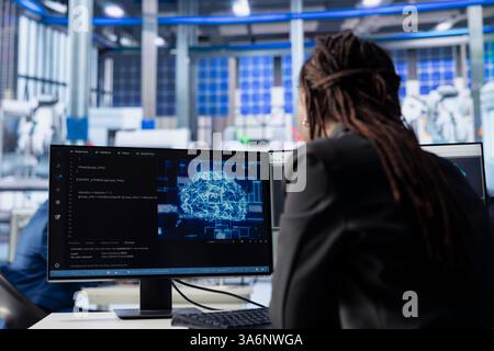 Engineer developing AI algorithms on PC in solar panel plant, training models to predict equipment failures. Technician integrating machine learning solutions to enhance production efficiency Stock Photo