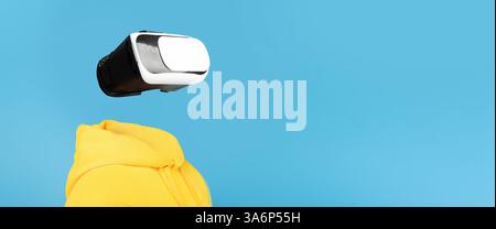 User interacts with modern VR headset in creative technology collage Stock Photo