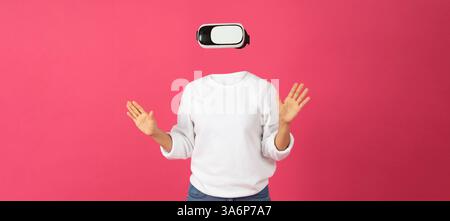 User interacts with VR goggles in a lively setting Stock Photo