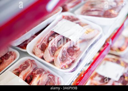 Packaged mutton meat laid out on display shelves of butcher store Stock ...