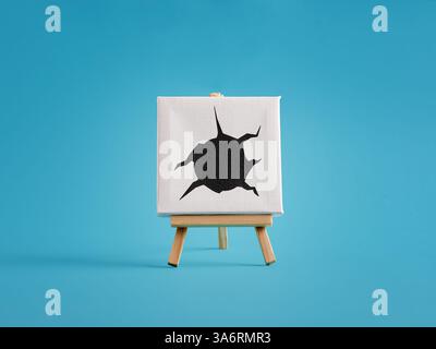 Poartraying damage, destruction , crime and violance. Black bullet hole is expanding from the center of a white canvas on a wooden easel against a blu Stock Photo