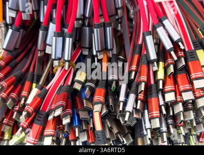 Different types of charger connectors for phones texture background. Charging or data cables. Stock Photo