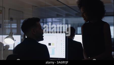 Computer, teamwork and night with business people in office for mentor, web designer and planning. Deadline, client briefing and UI software with Stock Photo