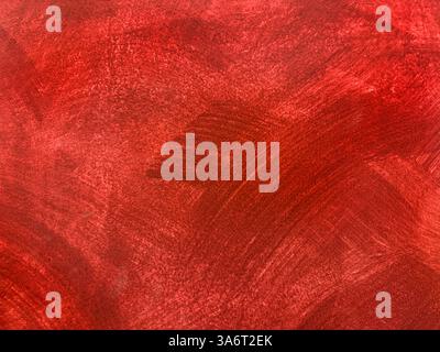 Decorative red textured paint on a wall or panel. Red washed paint with random brush strokes, grunge, and dirt pattern. Seamless background texture Stock Photo