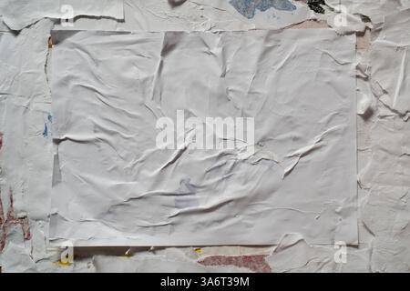 Wheatpaste poster style texture on a dirty wall Stock Photo