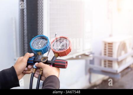 Technician is checking air conditioner. Stock Photo
