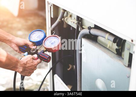 air condition outdoor unit compressor install outside the building. Stock Photo