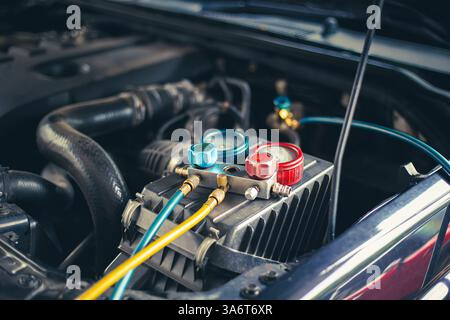 Car air conditioner check service, leak detection, fill refrigerant.Device and meter liquid cooling in the car by specialist technicians. Stock Photo