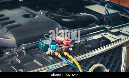 Car air conditioner check service, leak detection, fill refrigerant.Device and meter liquid cooling in the car by specialist technicians. Stock Photo