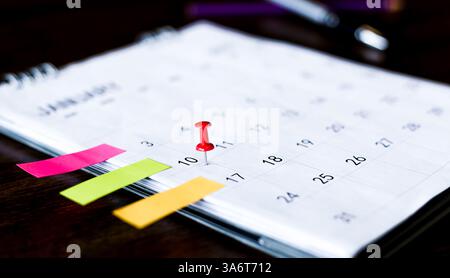 Embroidered pins on a calendar appointment Stock Photo