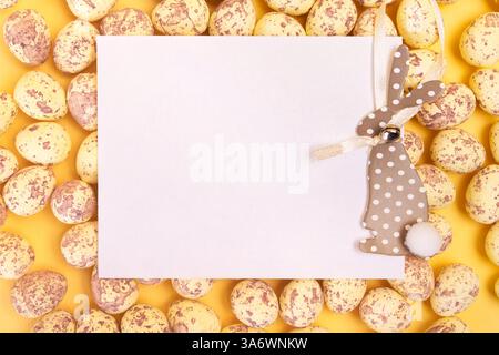 White blank postcard with easter bunny laying on easter eggs. Happy easter greeting card mockup Stock Photo