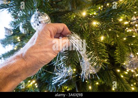Christmas tree is decorated with silver tinsel, Germany Stock Photo
