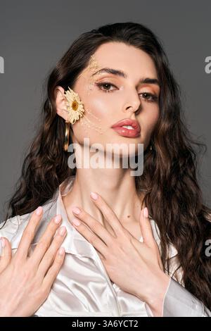 A young woman with brown hair poses among bright flowers, radiating spring spirit. Stock Photo