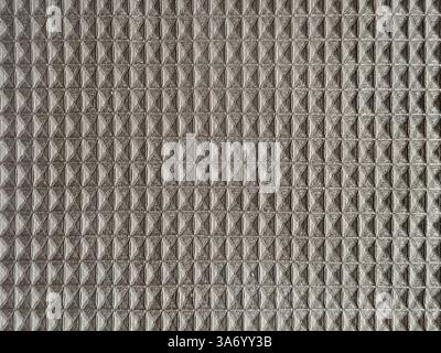 Close up fabric in geometrical checkered and triangular pyramid pattern, in dark brown color. Beveled checkered shapes fabric, seamless background tex Stock Photo