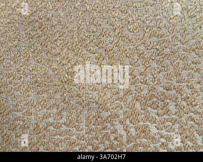 Close up of decorative gold fabric in random round ripples or clouds pattern texture. Bronze gold fabric seamless background texture. Stock Photo