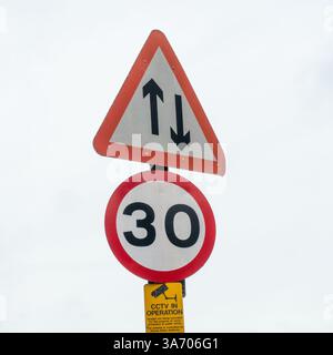 Two way traffic and 30 mph road signs closeup Stock Photo