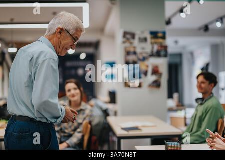 Elderly professor engaging with students in a modern classroom setting Stock Photo