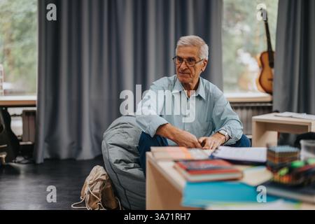 Professor engaging with students in a creative educational setting Stock Photo