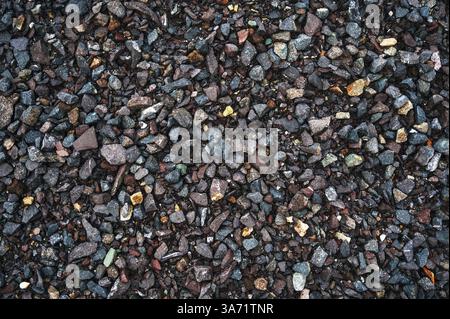 dark background of crushed granite gravel, close up. Stock Photo