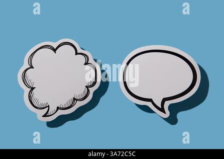 Two blank thought bubbles on blue background Stock Photo