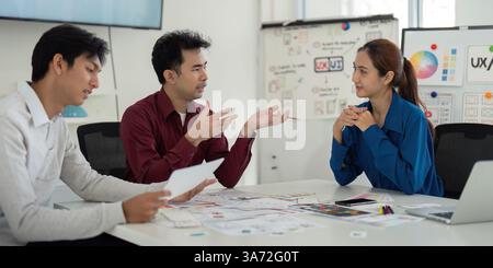 Interactive Feedback Session and UX Collaboration. Team sharing insights and feedback during a UX design discussion. Stock Photo