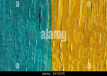 Close-up of peeling yellow and turquoise paint Stock Photo